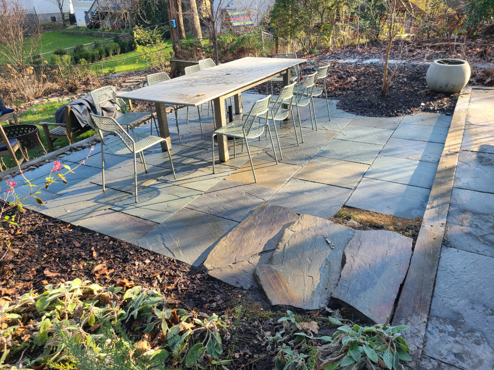 stone patio with planter and furniture